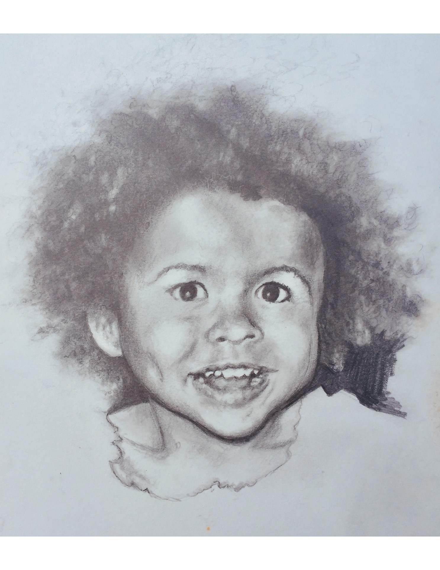 Graphite portrait drawing of a smiling child